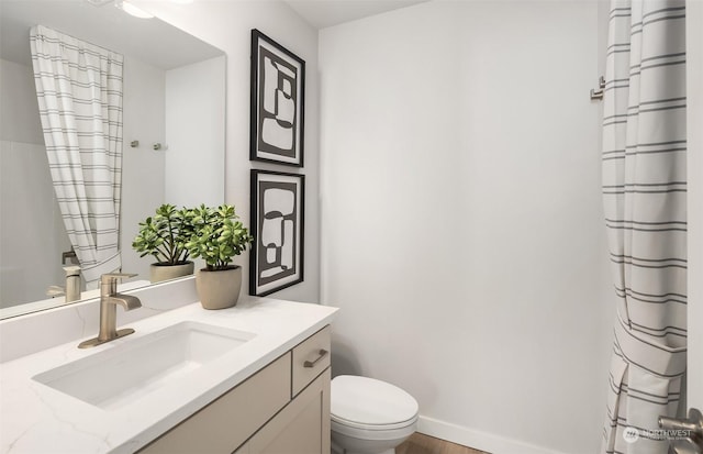 bathroom featuring toilet and vanity