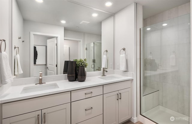 bathroom with walk in shower and vanity