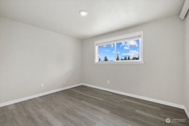 spare room with dark hardwood / wood-style flooring