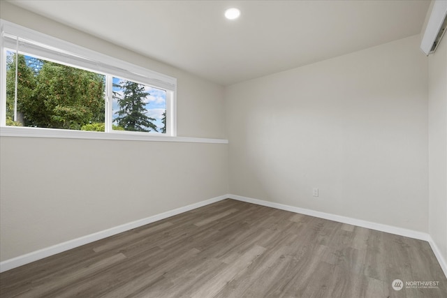 unfurnished room with wood-type flooring