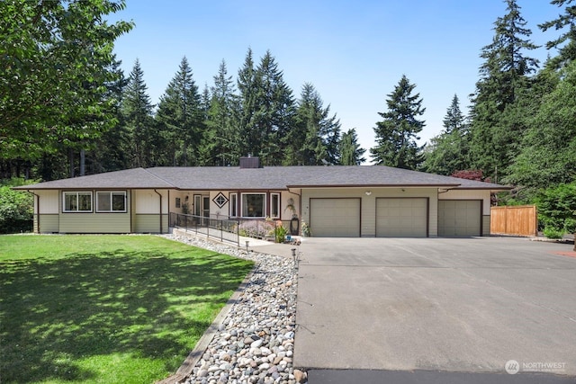 ranch-style home featuring a front yard and a garage