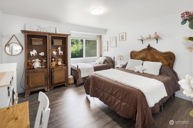 bedroom with dark hardwood / wood-style flooring