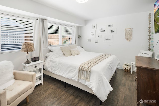 bedroom with dark hardwood / wood-style floors