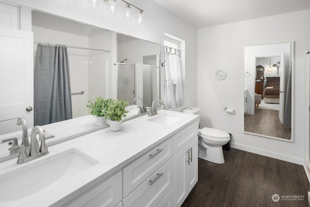 bathroom featuring hardwood / wood-style floors, toilet, vanity, and a shower with curtain