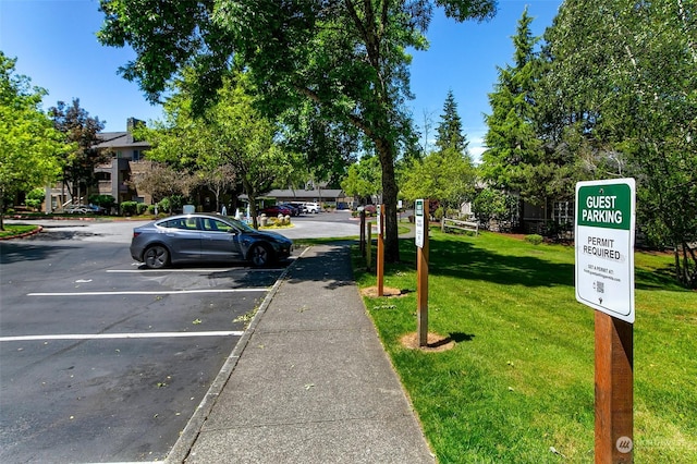 view of parking / parking lot with a yard