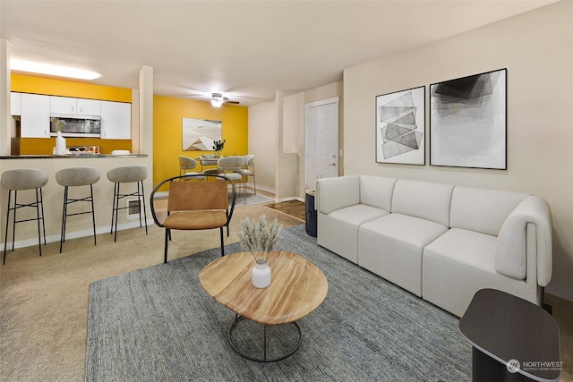 living room with light carpet and ceiling fan