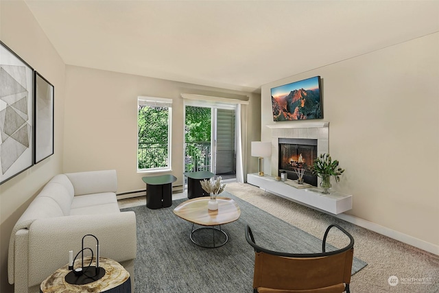 carpeted living room with baseboard heating and a tiled fireplace