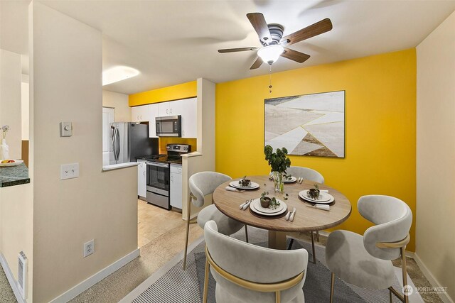 dining space featuring ceiling fan