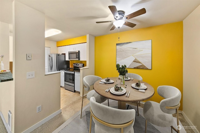 dining space with ceiling fan