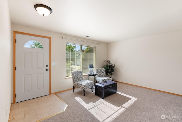 foyer entrance featuring carpet floors and baseboards