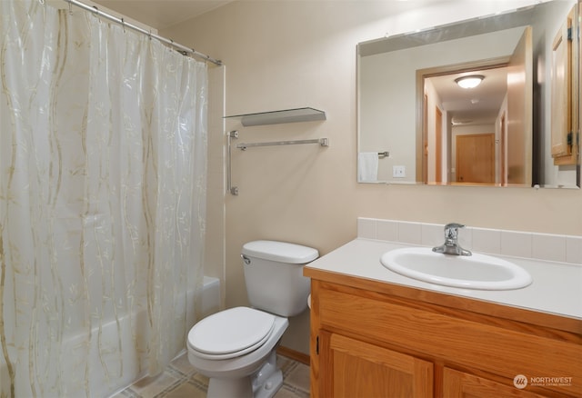 full bathroom with tile patterned flooring, shower / bath combo with shower curtain, toilet, and vanity