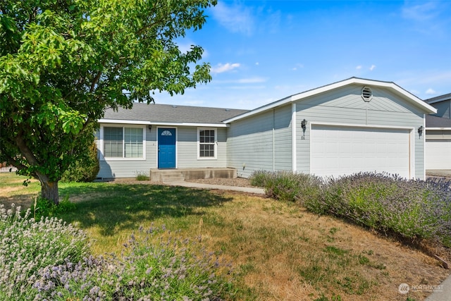 ranch-style house with a garage and a front yard