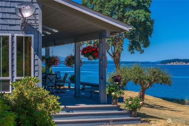 exterior space featuring a deck with water view