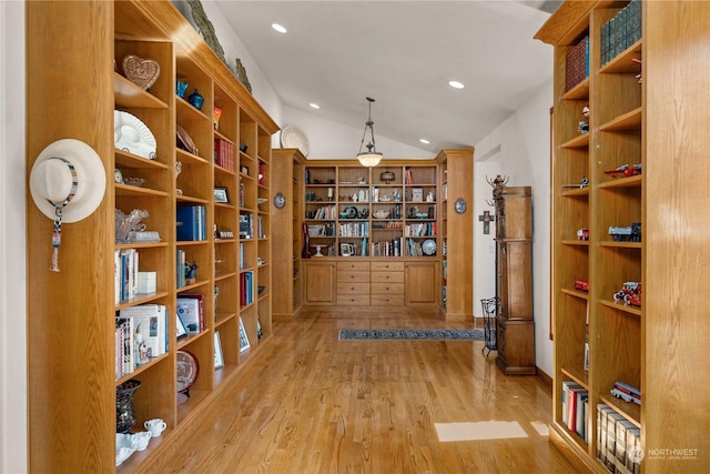 wine area with lofted ceiling and light hardwood / wood-style floors