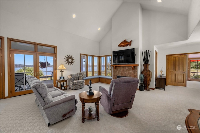 living room with french doors, a healthy amount of sunlight, and light carpet