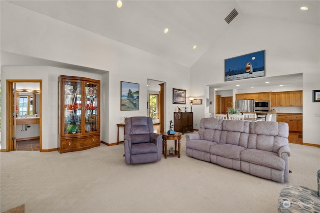 living room featuring high vaulted ceiling and light colored carpet