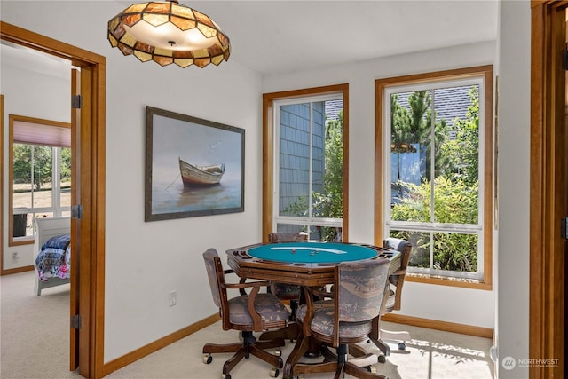 recreation room featuring plenty of natural light and light colored carpet