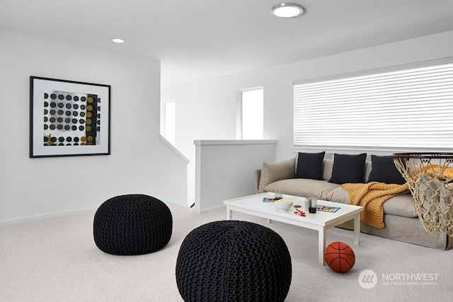 living room with a wealth of natural light and light carpet