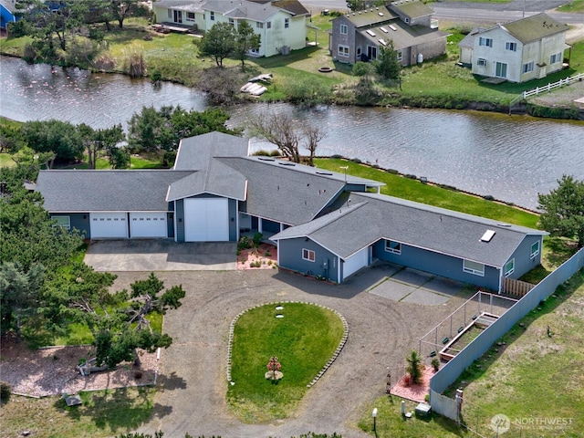 drone / aerial view with a residential view and a water view