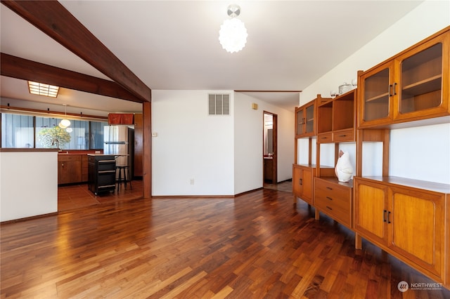 empty room with beam ceiling, dark hardwood / wood-style flooring, and sink