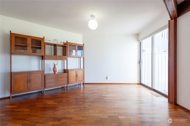 empty room with dark hardwood / wood-style flooring