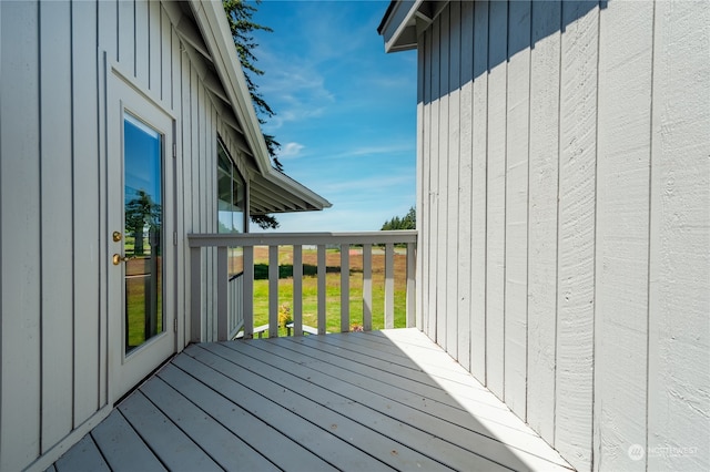 wooden deck featuring a lawn