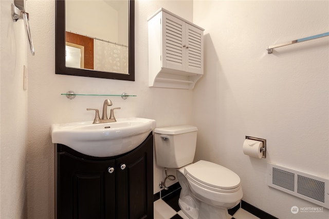 bathroom with vanity and toilet