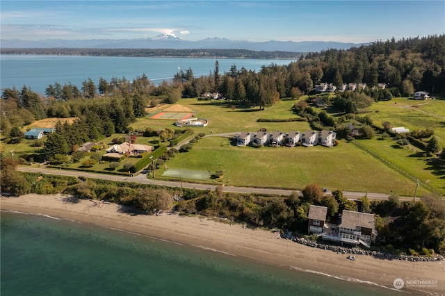 drone / aerial view featuring a water and mountain view