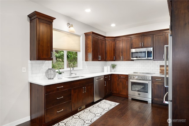 kitchen featuring dark wood-type flooring, appliances with stainless steel finishes, decorative backsplash, dark brown cabinetry, and sink