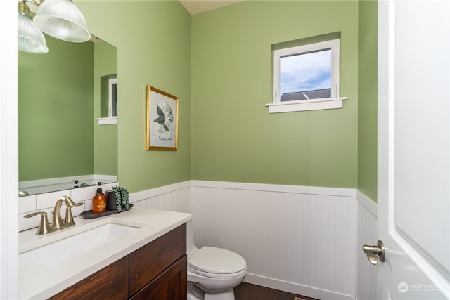 bathroom featuring hardwood / wood-style floors, vanity, and toilet