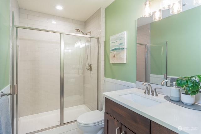 bathroom with vanity, toilet, and walk in shower