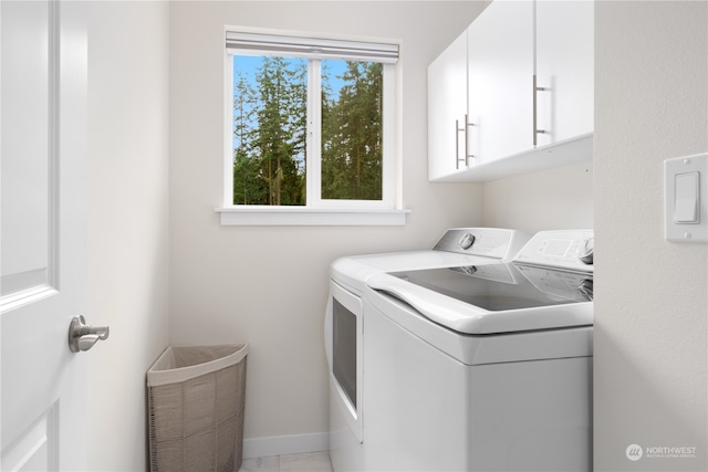 washroom with separate washer and dryer and cabinets