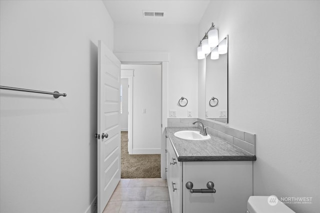 bathroom featuring vanity, toilet, and tile patterned floors