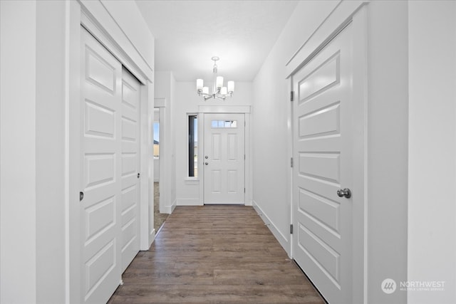 interior space with an inviting chandelier and hardwood / wood-style flooring