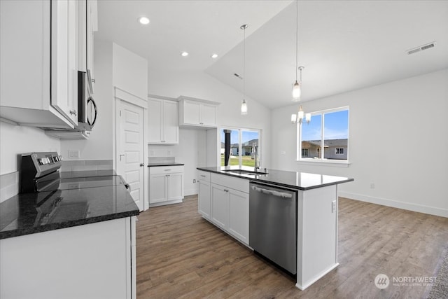 kitchen with wood-type flooring, sink, white cabinetry, a center island with sink, and appliances with stainless steel finishes