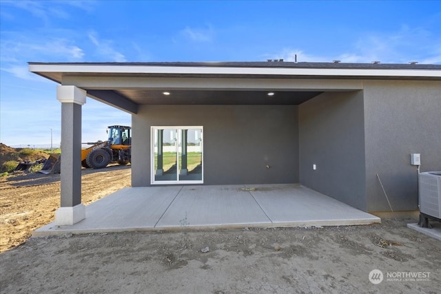 exterior space with central AC and a patio area