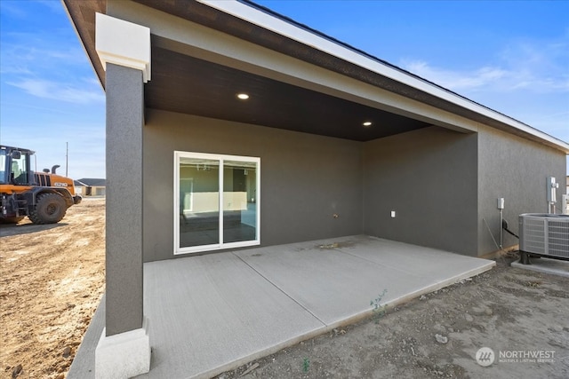 back of property with cooling unit and a patio area