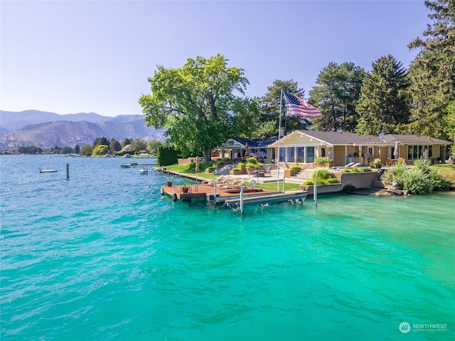 view of dock featuring a water and mountain view