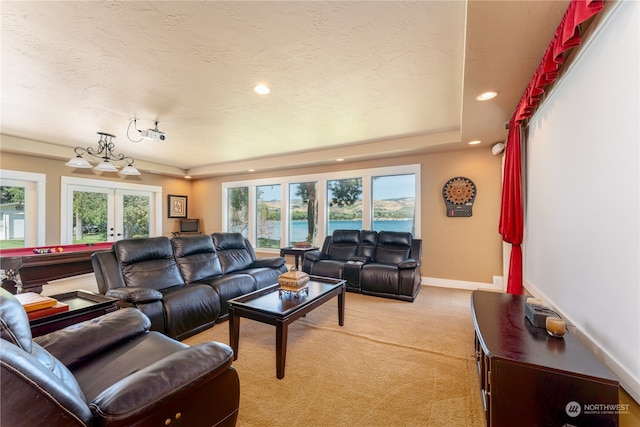 carpeted living room featuring a healthy amount of sunlight and french doors