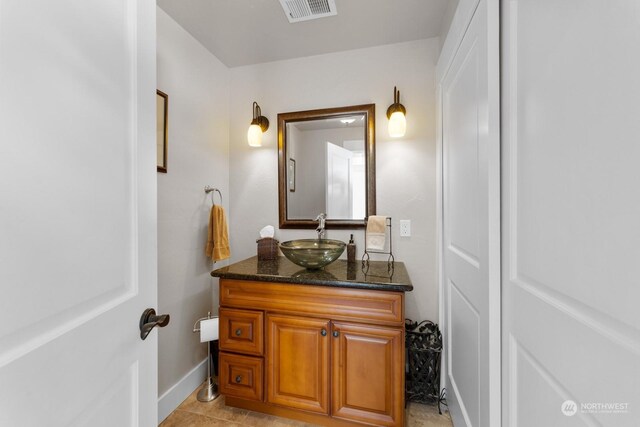 bathroom featuring tile patterned flooring and vanity