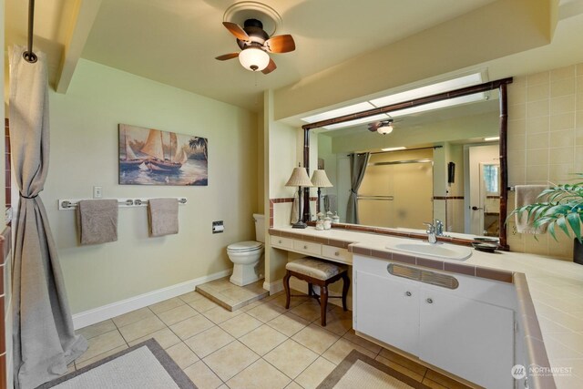 bathroom featuring tile patterned floors, vanity, ceiling fan, and toilet