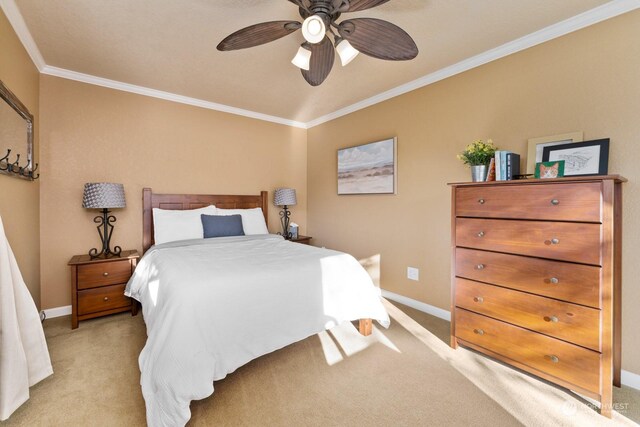 carpeted bedroom featuring ceiling fan and ornamental molding