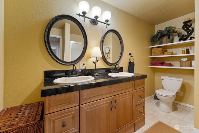 bathroom featuring double vanity, toilet, and tile patterned floors