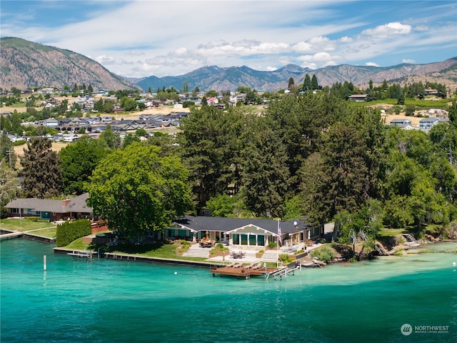 drone / aerial view featuring a water and mountain view