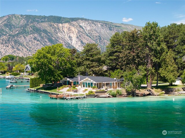 drone / aerial view featuring a water and mountain view