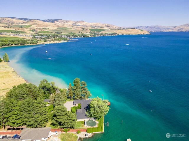 birds eye view of property with a water and mountain view