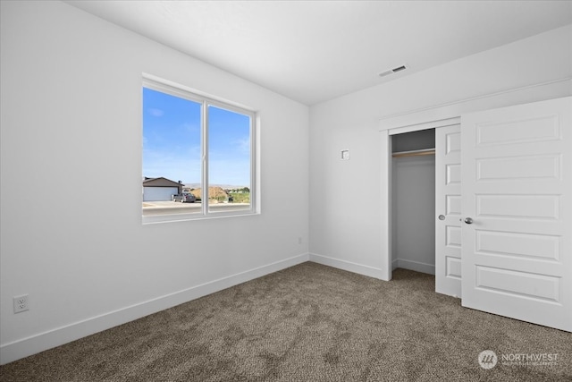 unfurnished bedroom with carpet floors and a closet