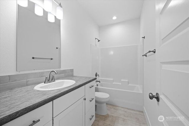 full bathroom featuring tile patterned flooring, bathing tub / shower combination, vanity, and toilet