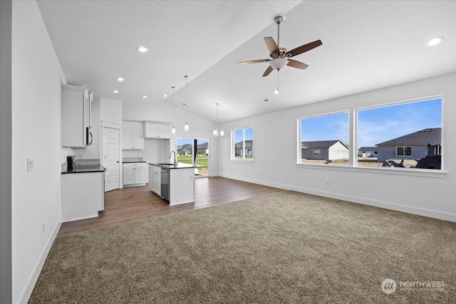 unfurnished living room featuring lofted ceiling, ceiling fan, dark hardwood / wood-style floors, and sink