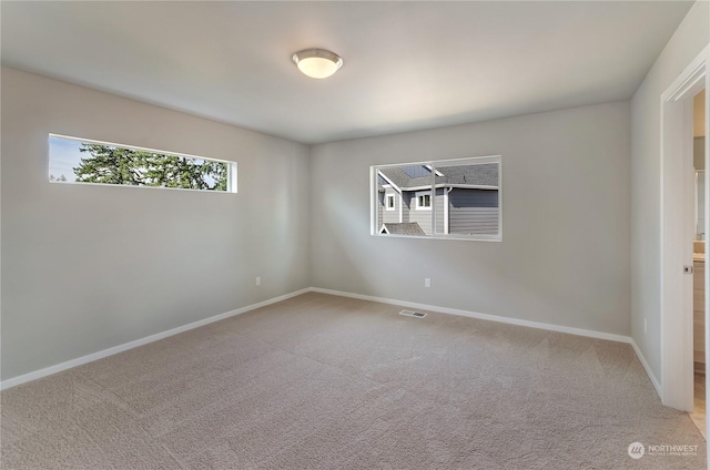 empty room with light colored carpet